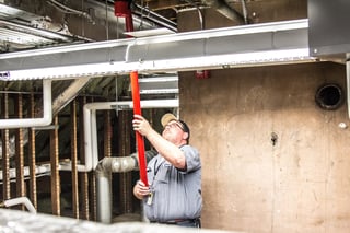 Koorsen Technician Testing Smoke Detector