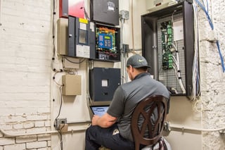 Koorsen Technician Monitoring Fire Alarm Panel for Testing